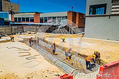 Unidentified construction workers building new Editorial Stock Photo