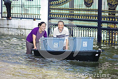 Unidentified couple pushes boat Editorial Stock Photo
