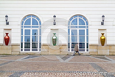 An unidentified executive in Luxembourg hurrying up along foreside of an administration building Editorial Stock Photo