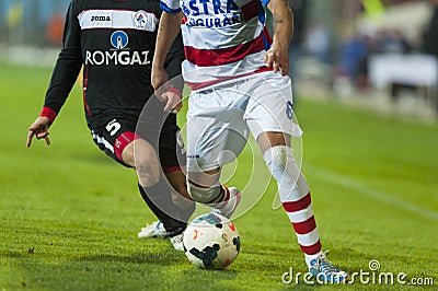 Unidentified football players compete during the OTELUL GALATI (WHITE) vs Gaz Meta (BLACK), Editorial Stock Photo