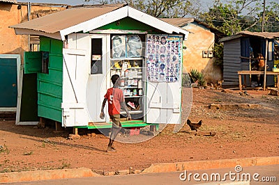 Unidentified Ghanaian boy passes by the stall in local village. Editorial Stock Photo