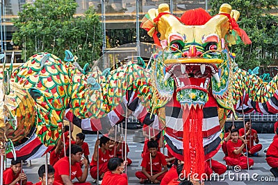Unidentified group of people perform a traditional dragon dance at Iconsiam to celebrate traditional Chinese`s lunar new year Editorial Stock Photo