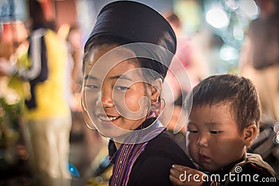 Unidentified Hmong Girl Carrying Baby in Sapa, Lao Cai,Vietnam Editorial Stock Photo