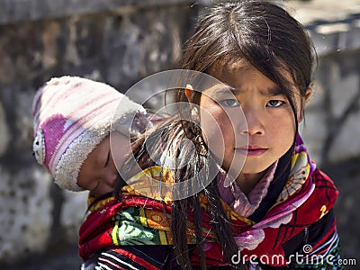 Unidentified Hmong Girl Carrying Baby in Sapa, Vietnam Editorial Stock Photo