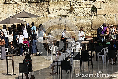 Unidentified Jews women watching through the fence to the female sector of the conduct Bar Mitzvah ceremony near Western Wall Editorial Stock Photo