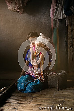 Unidentified Karen Long Neck woman with her baby from ethnic group of hill tribe minority of northern Thailand. Famous tourist tra Editorial Stock Photo