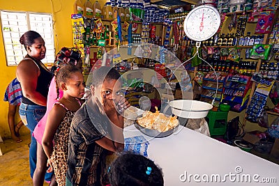 Unidentified kids and woman in unidentified local shop near Cabral, Dominican Republic Editorial Stock Photo