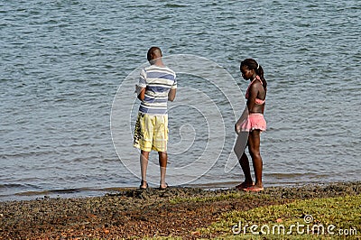 Unidentified local couple look at the water on the coast of the Editorial Stock Photo