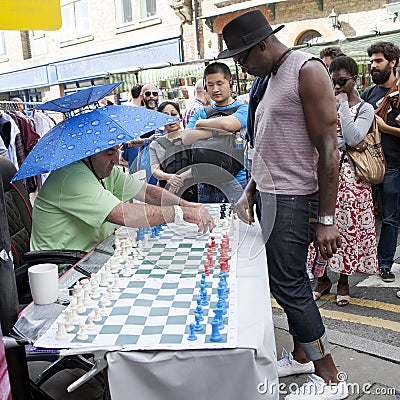 Unidentified local people played chess at Brick lane street in London UK. Editorial Stock Photo