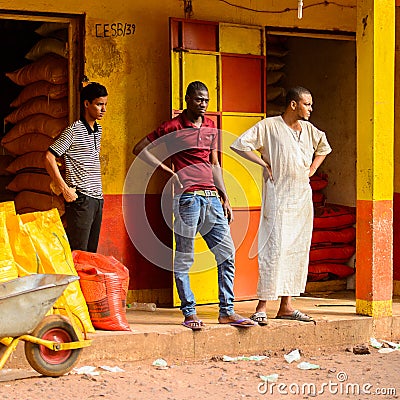 Unidentified local three men stand near the stock in a village Editorial Stock Photo