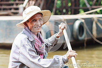 An unidentified man smiles Kompong Phluk paddling a boat Editorial Stock Photo
