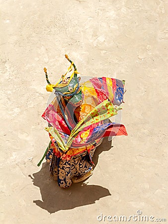 Monk in a bull deity mask with ritual dagger phurpa performs a religious masked and costumed Cham dance of Tibetan Buddhism Stock Photo