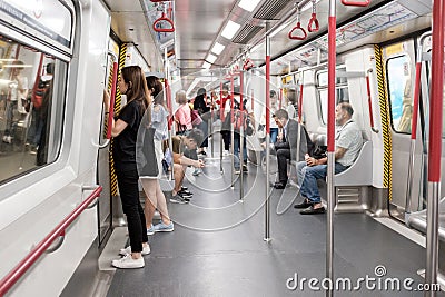 Unidentified passengers browsing smartphone in Hong Kong subway system Editorial Stock Photo