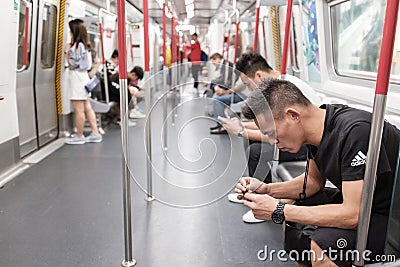 Unidentified passengers in Hong Kong subway system Editorial Stock Photo