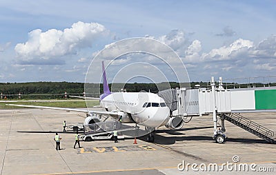 Unidentified people and airplane connected to the jetway Stock Photo