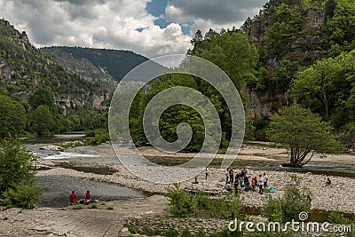 Unidentified people on the banks of the Tarn River, Sainte-Enimie, Occitania, France Editorial Stock Photo