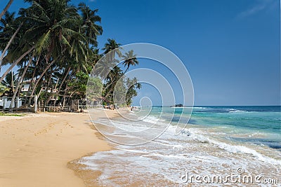 Unidentified people on the beach at Hikkaduwa. Hikkaduwa's beach and night life make it a popular tourist destination. Stock Photo