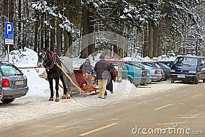 Unidentified people on the horse cart in snowy Zakopane town Editorial Stock Photo