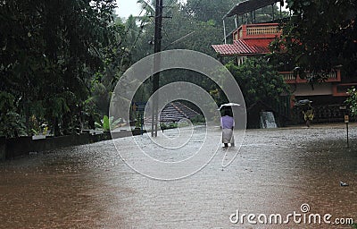 People walk through the flooded roads Editorial Stock Photo