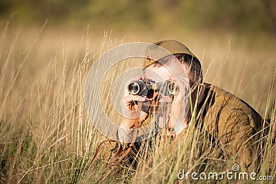 Unidentified re-enactor dressed as Soviet soldier looks at an old army Editorial Stock Photo