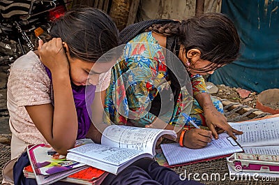 Unidentified school girls of Indian Ethnicity busy doing homework Editorial Stock Photo