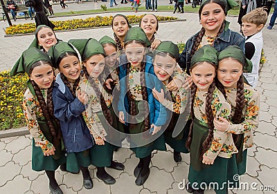 Unidentified school girls in national Georgian costumes playing together at the party Editorial Stock Photo