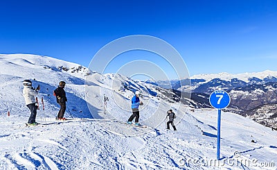 Unidentified skiers enjoy skiing at the slope in the Alps Editorial Stock Photo