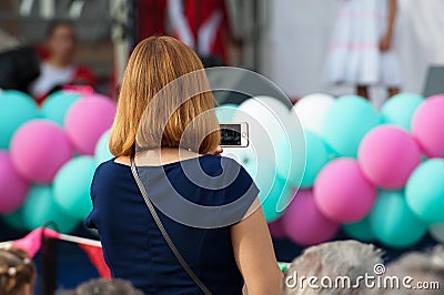 Unidentified spectator filming a concert Editorial Stock Photo