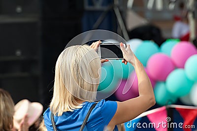 Unidentified spectator filming a concert Editorial Stock Photo