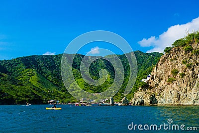 Unidentified tourists at the beautiful caribbean beach during a beautiful sunny day in Taganga, Colombia Stock Photo