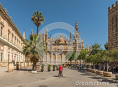 unidentified tourists in Plaza del Triunfo, Andalusia, Seville Editorial Stock Photo