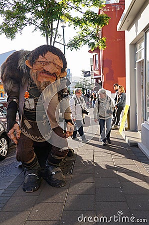 Unidentified tourists walking near Icelandic trolls on streets o Editorial Stock Photo