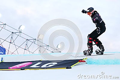 Unidentified woman competitor balances on snowboard Editorial Stock Photo