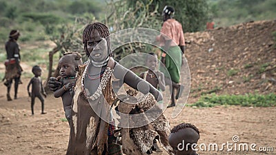 Unidentified woman with her baby from the tribe of Hamar in the Omo Valley of Ethiopia Editorial Stock Photo