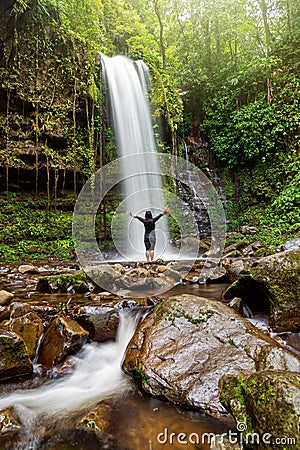 Unidentified Woman Standing at Mahua Waterfall Stock Photo