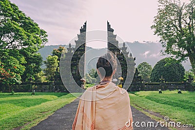 Woman at the traditional gate in Bali Editorial Stock Photo