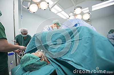 An unidentified woman are undergoing cesarean delivery by a medical team Editorial Stock Photo