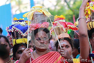 Women devotees carry scared pots in their heads and participates in the Thaipusam festival Editorial Stock Photo