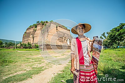 An unidentified women sells postcard in front of Mingun Pa Hto Daw Gyi pagoda Myanmar. Editorial Stock Photo