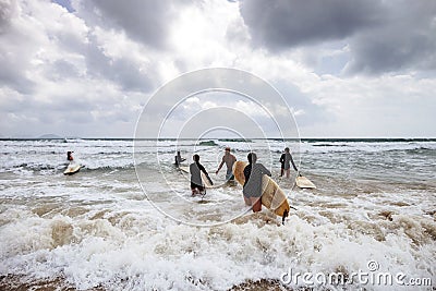 Unidentified women surfers with surfing boards coming to the sea Editorial Stock Photo