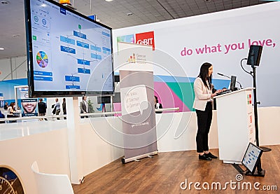Unidentified young woman makes presentation at Startup Stage lecture hall Editorial Stock Photo