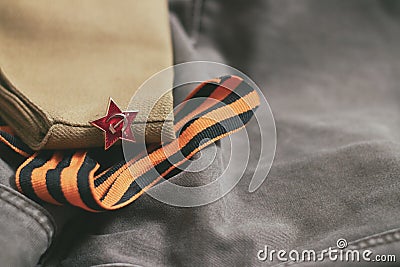 Uniform cap of a Soviet soldier of the WWII with a star. In memory of Victory Day on May 9th. Stock Photo