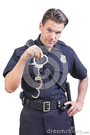 Uniformed police officer holding handcuffs Stock Photo