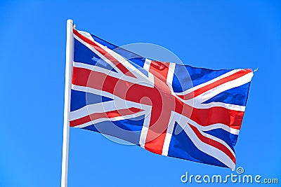 Union jack flag against a blue sky. Stock Photo