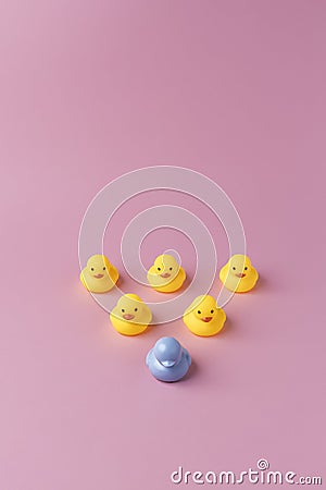 Unique blue duck toy in front of yellow ones Stock Photo