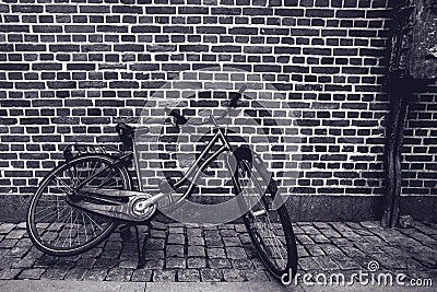 Unique classic vintage hipster bicycle leaning against the stree Stock Photo