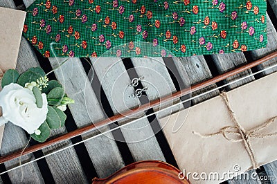 Unique cufflinks in the form of a violin key lie on a violin Stock Photo