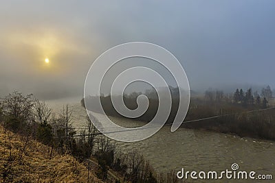 A unique dawn in the Carpathians with fog over a fast river. Stock Photo