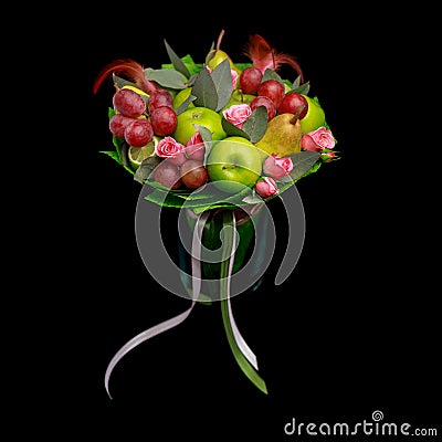 Unique handmade edible gift in the form of a bouquet of fruit standing in glass vase on a black background Stock Photo