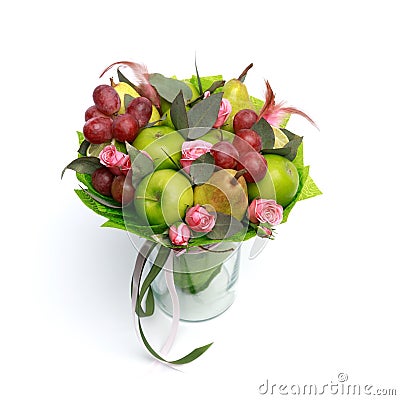 Unique handmade edible gift in the form of a bouquet of fruit standing in glass vase on a white background Stock Photo